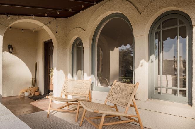 Dramatic arched black steel entry door — Arizona Spanish Revival