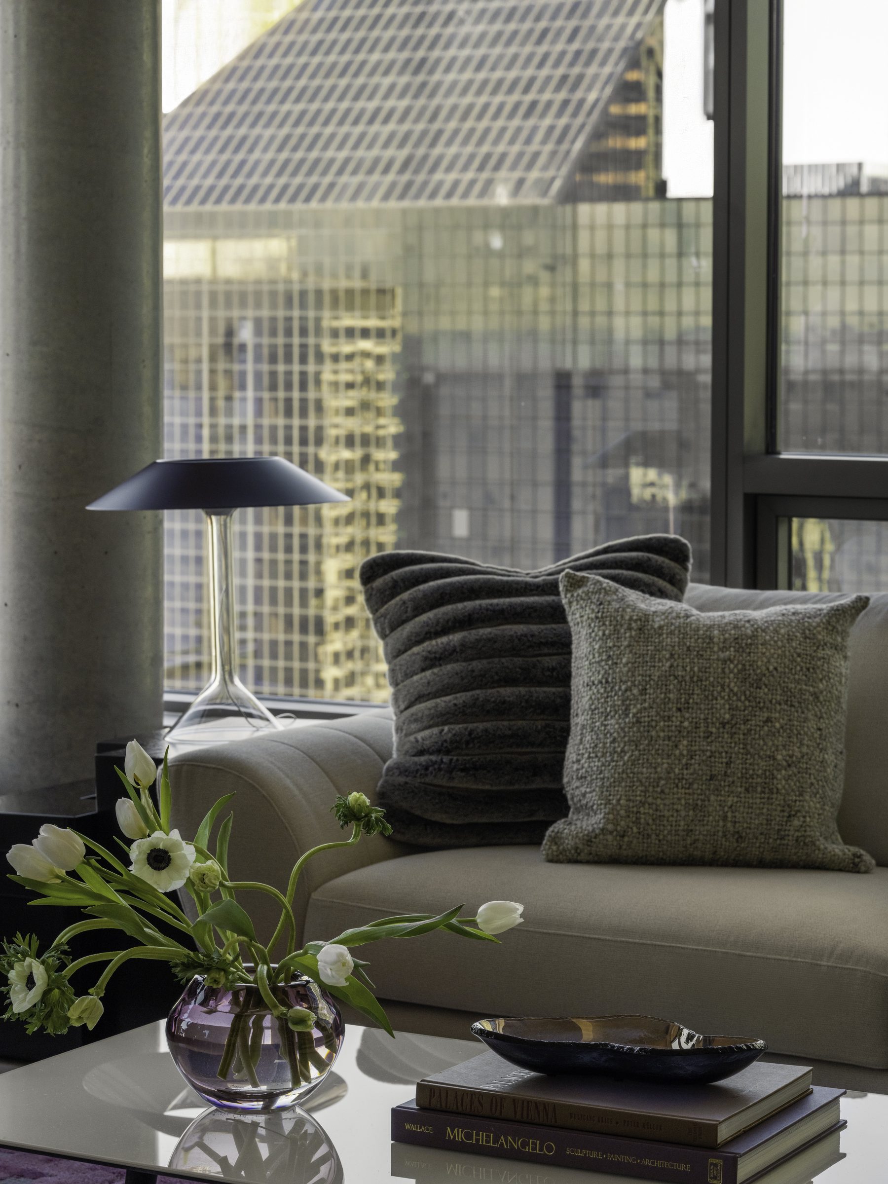 Living room with curated furniture and city backdrop, Downtown High Rise — Downtown, Seattle
